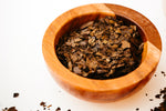 Yaupon tea in a bowl. Dark roast yaupon tea in a small wooden bowl.